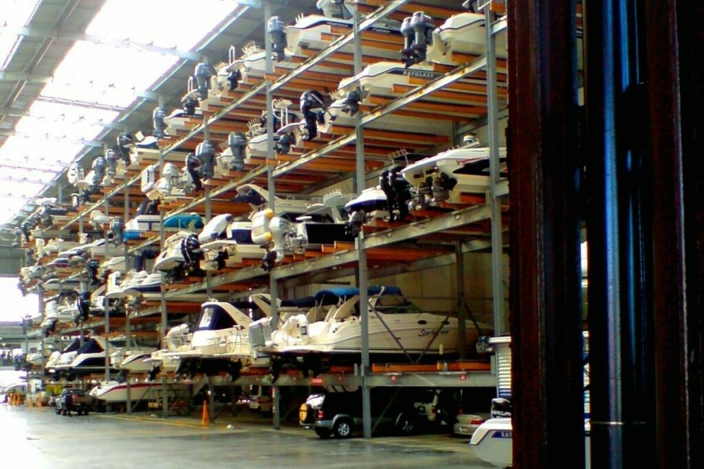 boats stacked up in a dry dock warehouse