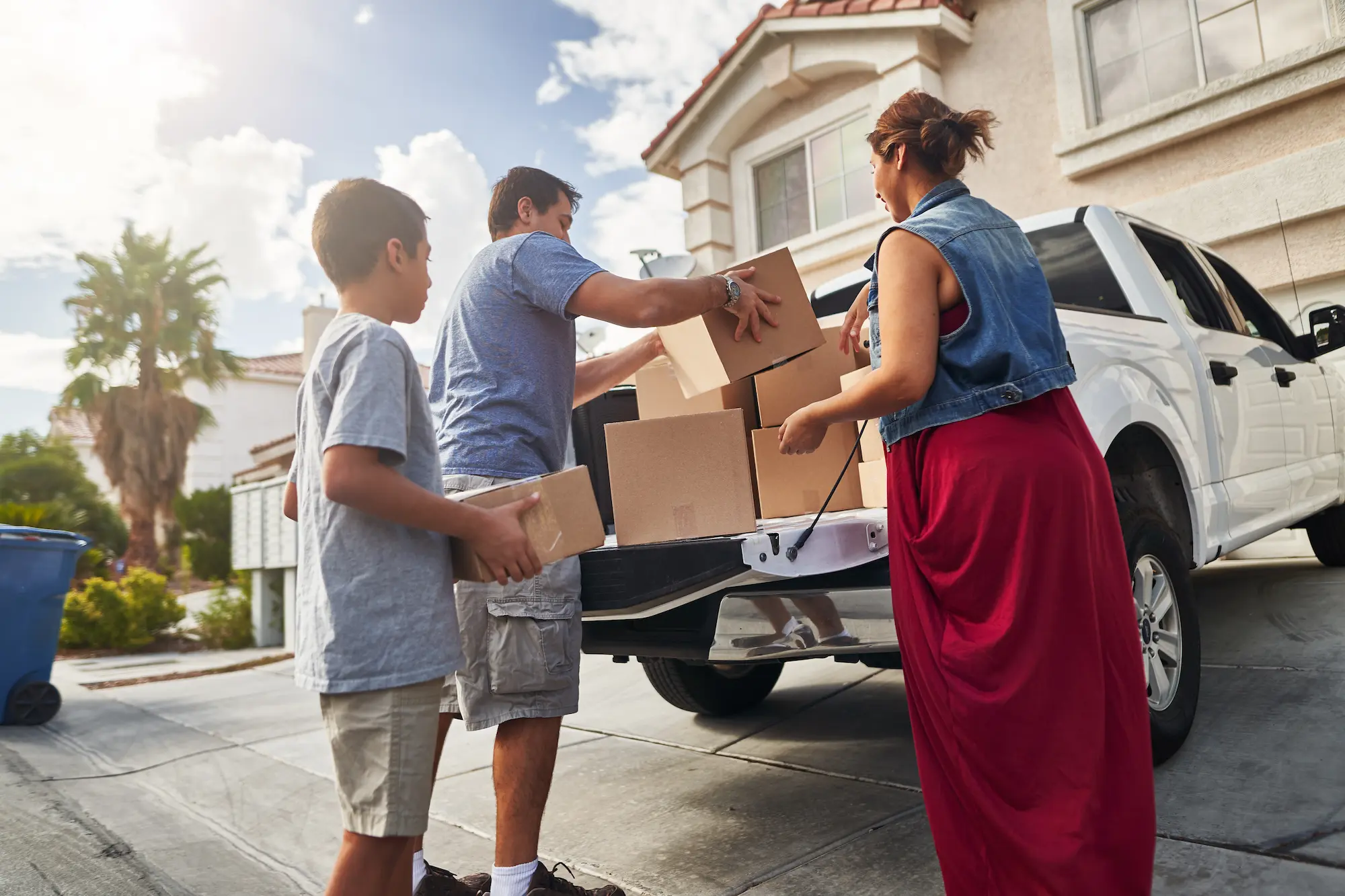 Family loading truck with items for storage