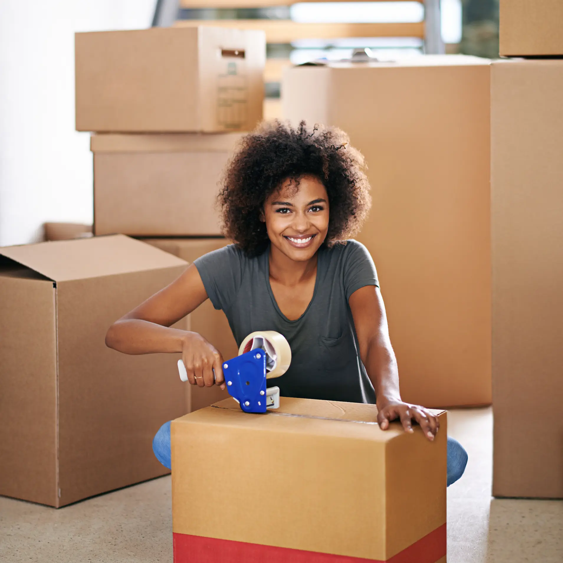 Smiling Woman Prepares Boxes in Home Environment Smiling Woman Prepares Boxes in Home Environment