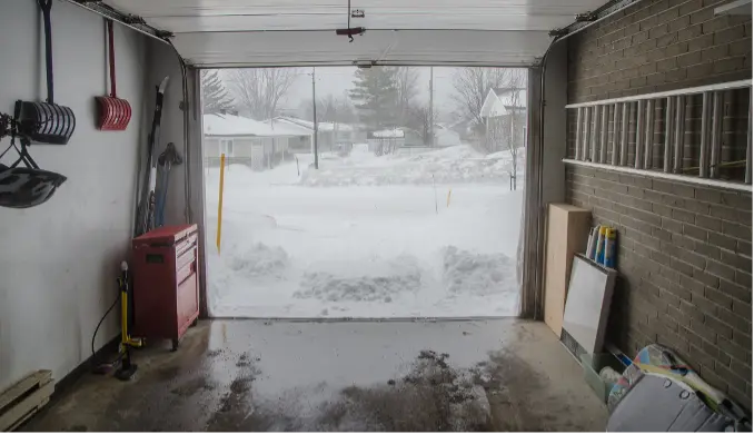 Cold and wet garage with snow outside Cold and wet garage with snow outside